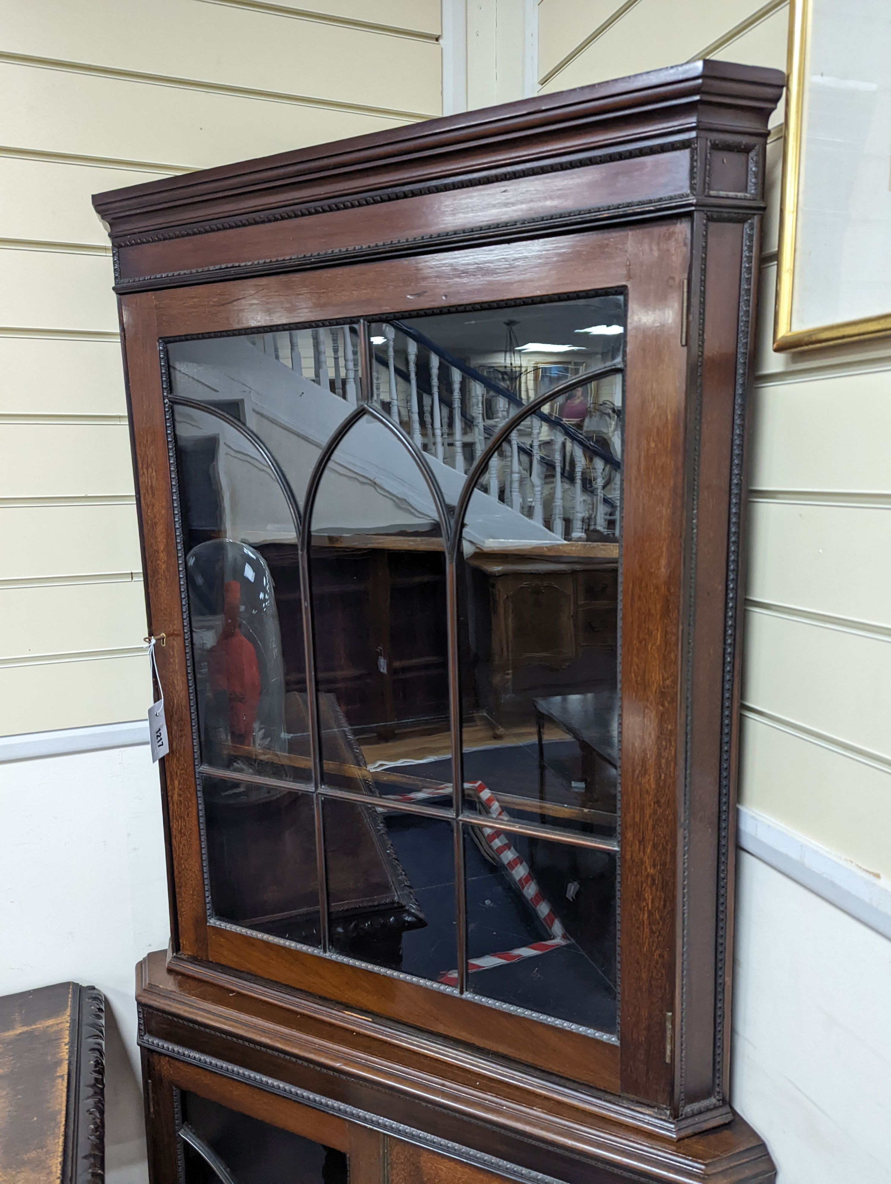 An Edwardian mahogany glazed standing corner cabinet, fitted four shelves, width 80cm, depth 42cm, height 196cm